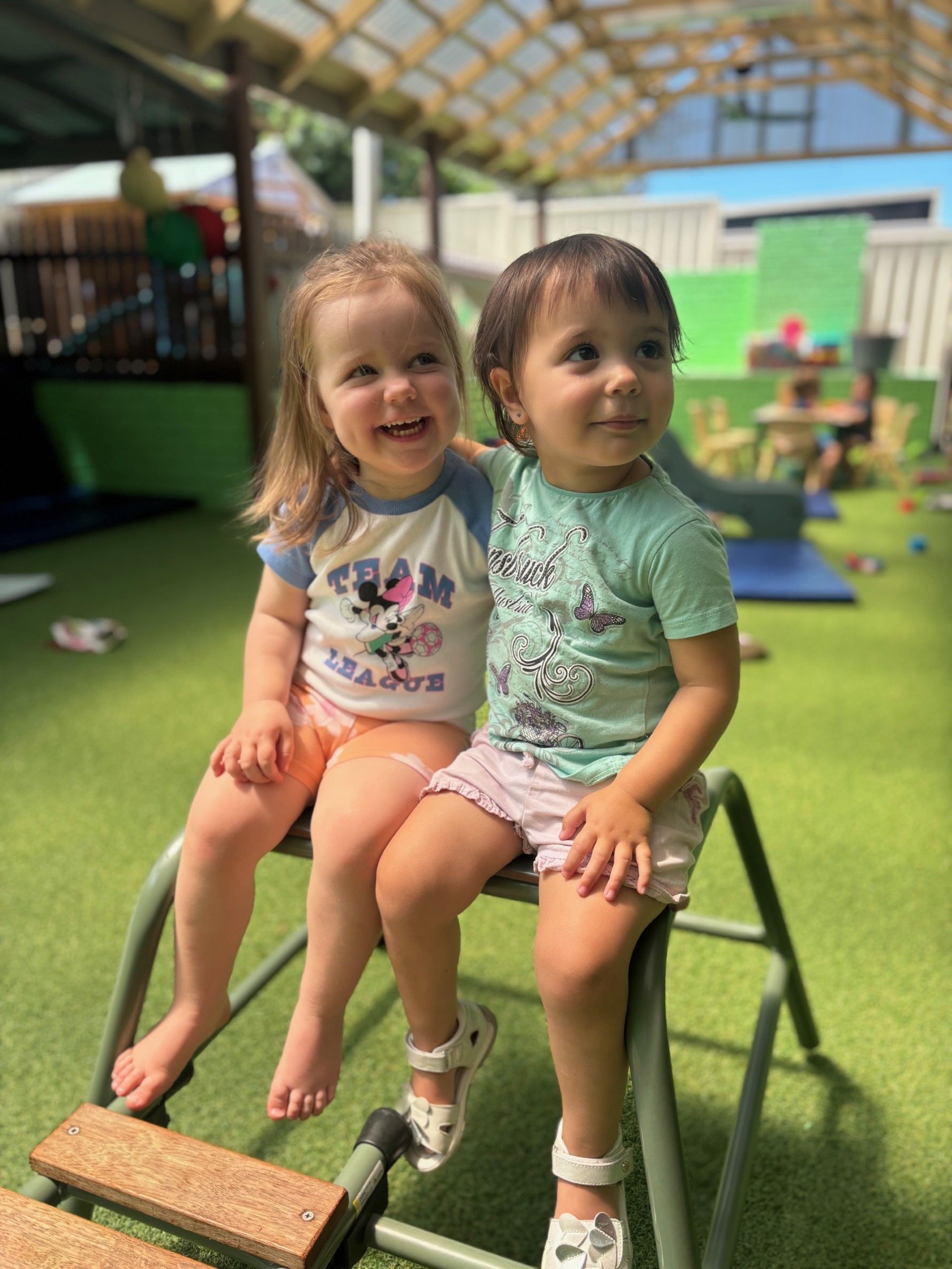 Two children enjoying outdoor play at Wattle & Wonder